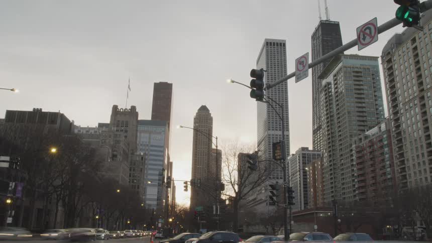 A busy intersection in a metropolis in the evening