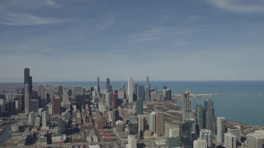 A city skyline made up of high rise buildings next to a large body of water