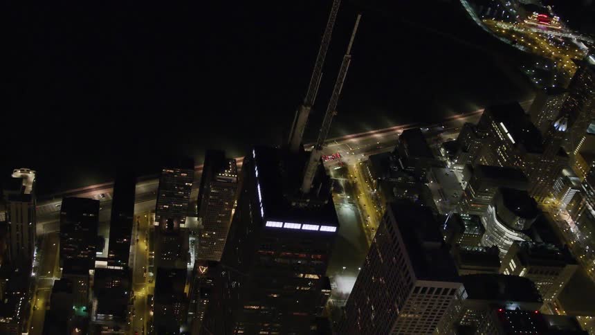 An aerial view of skyscrapers in a city at night