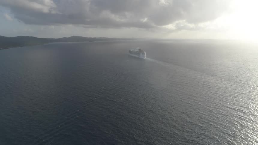 Cruise ship coasting on peaceful waters in early morning at sea
