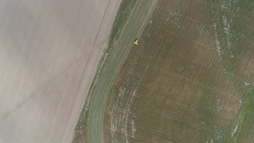 Farm equipment clearing fields