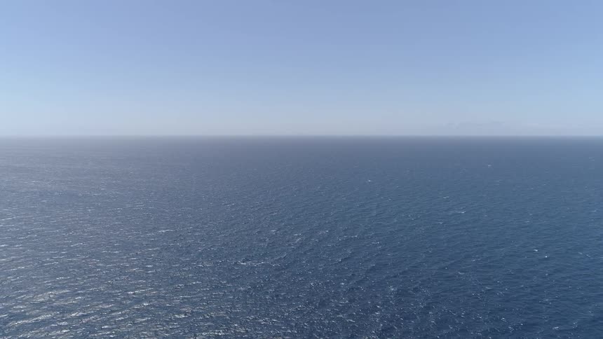 The ocean with the sky and clouds in the background