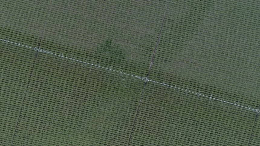 Irrigation equipment sits on a farm field