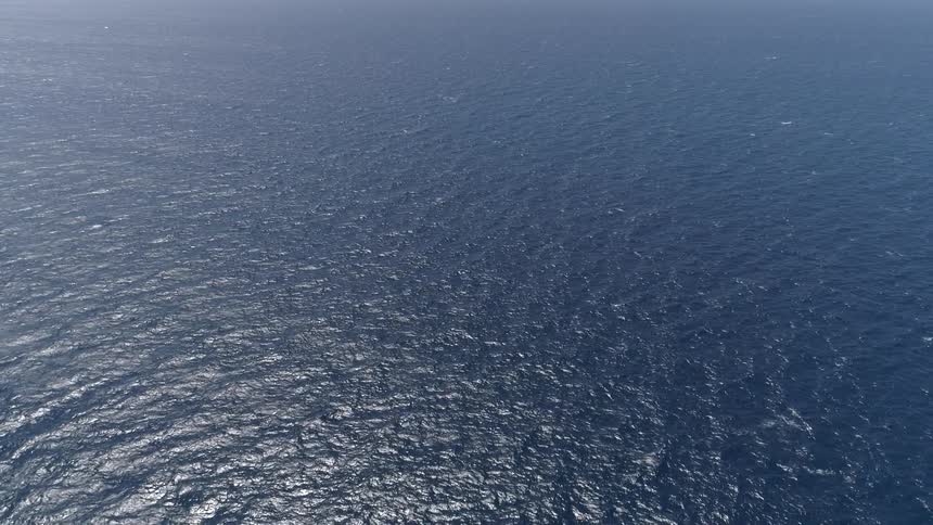Light reflecting on rippling ocean surface