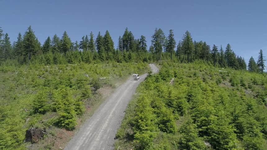 A vehicle driving on a dirt road