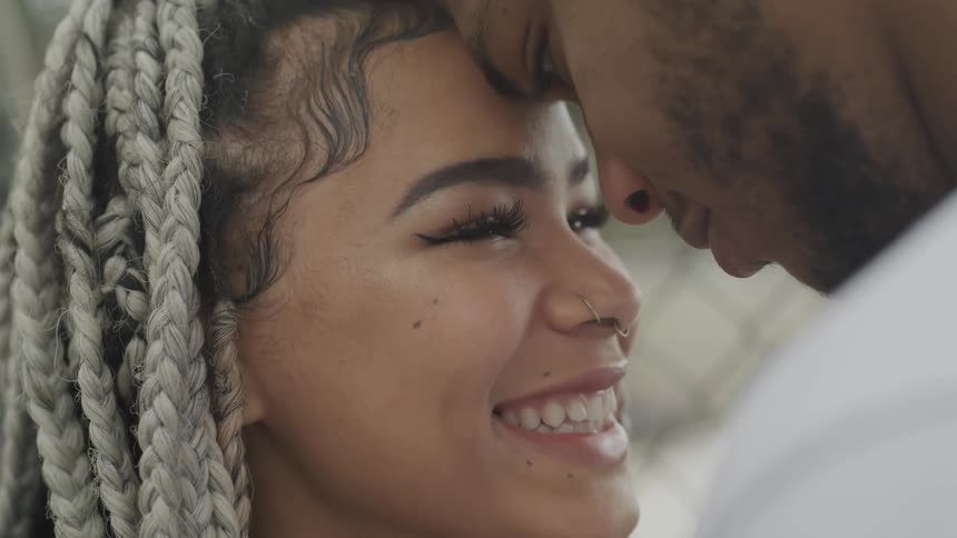 A couple touch their forehead romantically