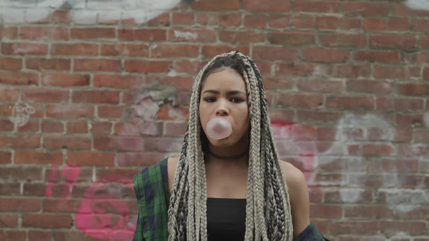 A woman blows a bubble