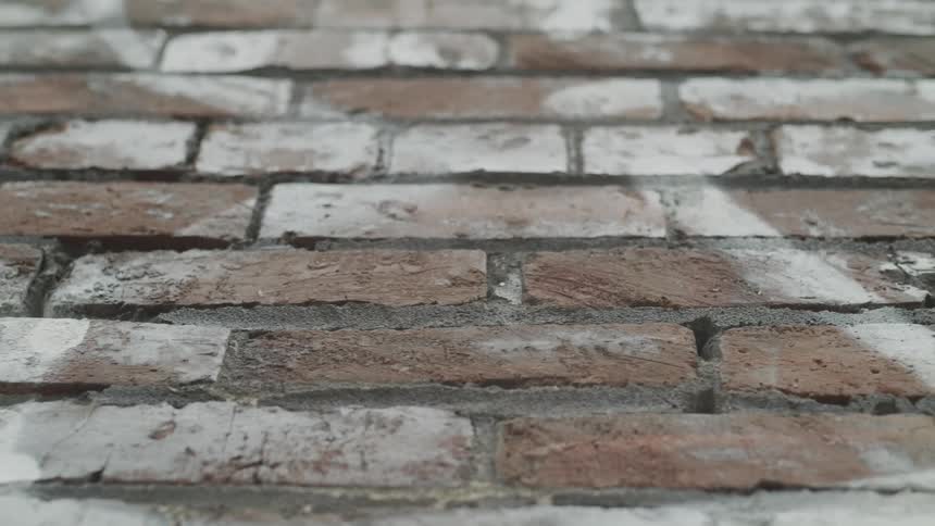 White painted lines on a red brick wall