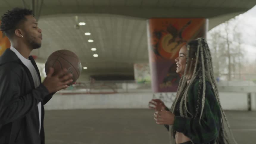 Male and female tossing ball