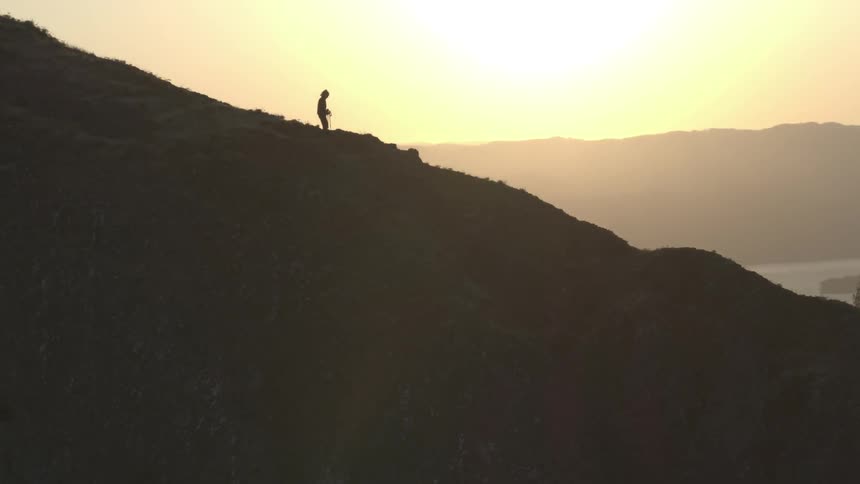 Human hiking down a hill
