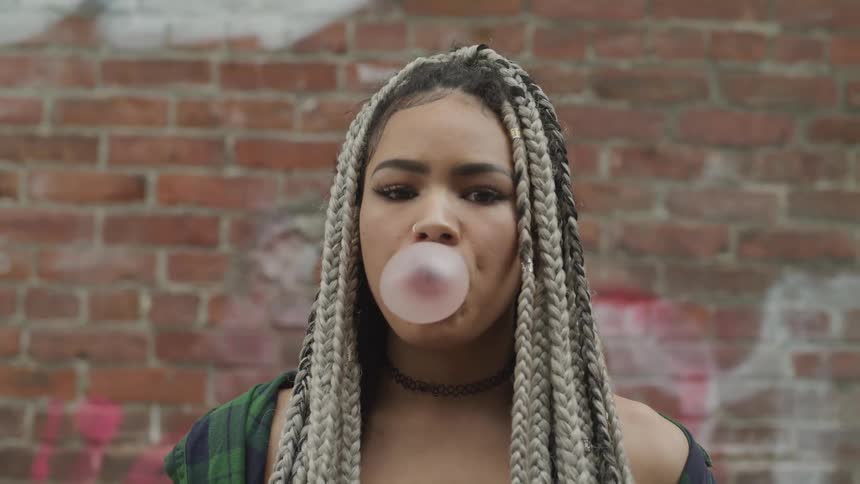 Girl blowing a bubble gum bubble
