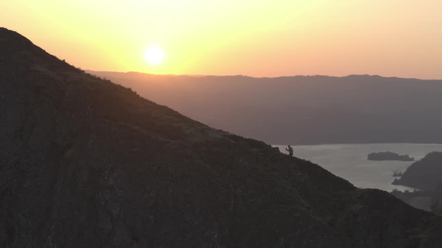 Aerial view of person hiking up a mountain