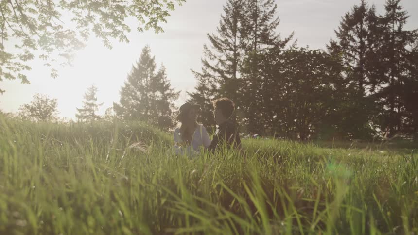 Girl and boy sitting in a field