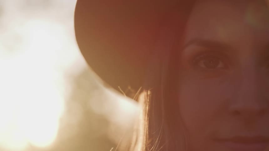 Girl looking at camera with flare in background
