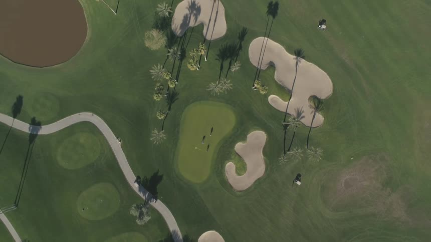 Golfers golfing on a golf course