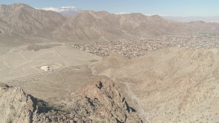 A town sits between the mountains ahead