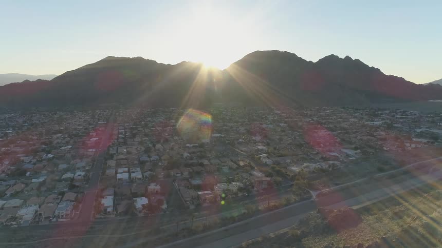 Sunlight arise between mountain at the urban area