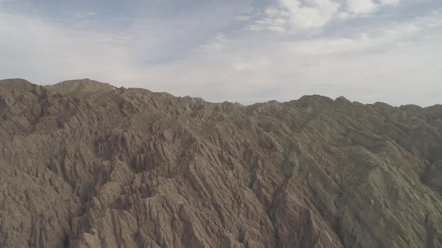 A craggy landscape stretches out under clouds