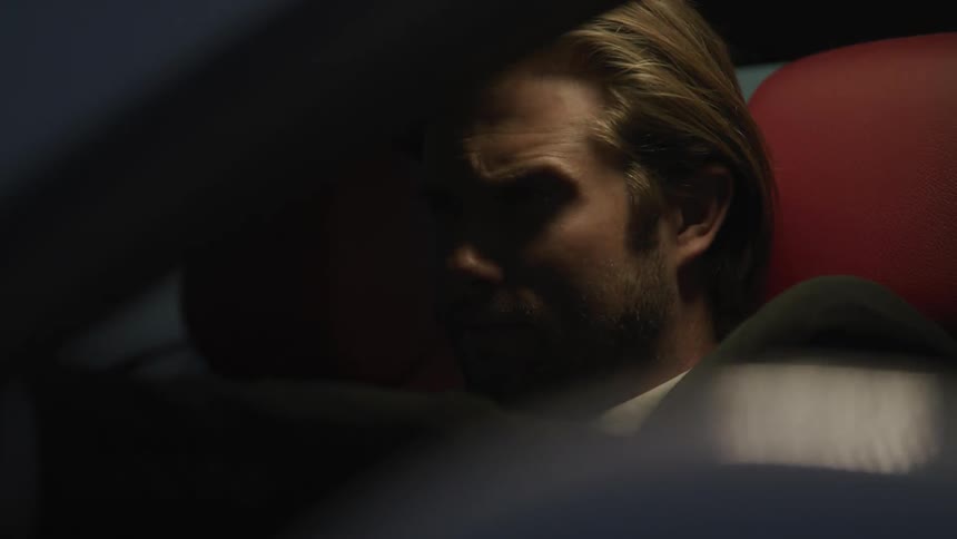 A man is driving in a car