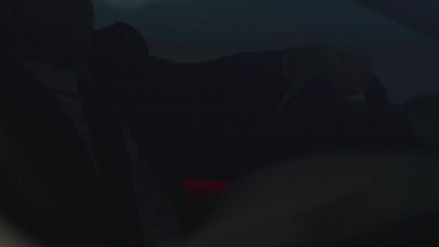 Lights hitting a man driving a car