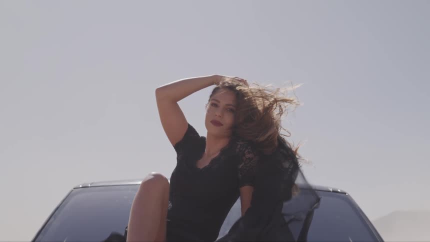 Wind blowing womans hair in a car