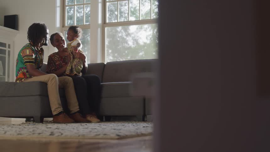 A family sits on the sofa