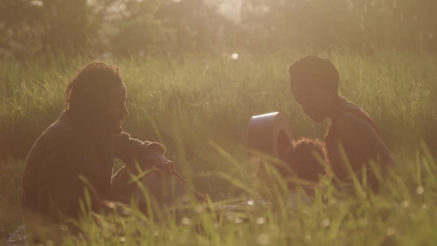Two people sitting in the grass