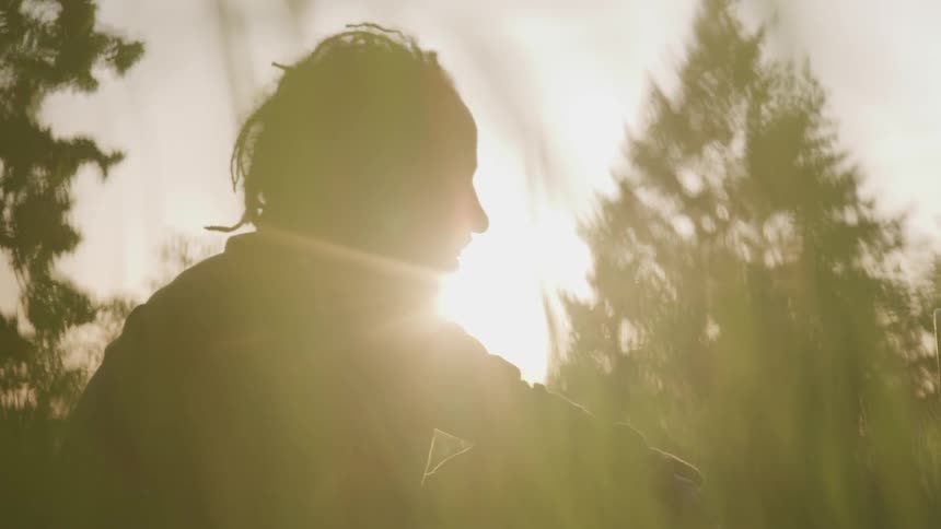 A man sits on the ground singing