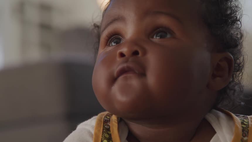 A baby is looking around in a room