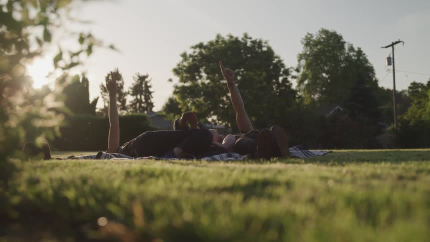 Family having a picnic in park at sunrise