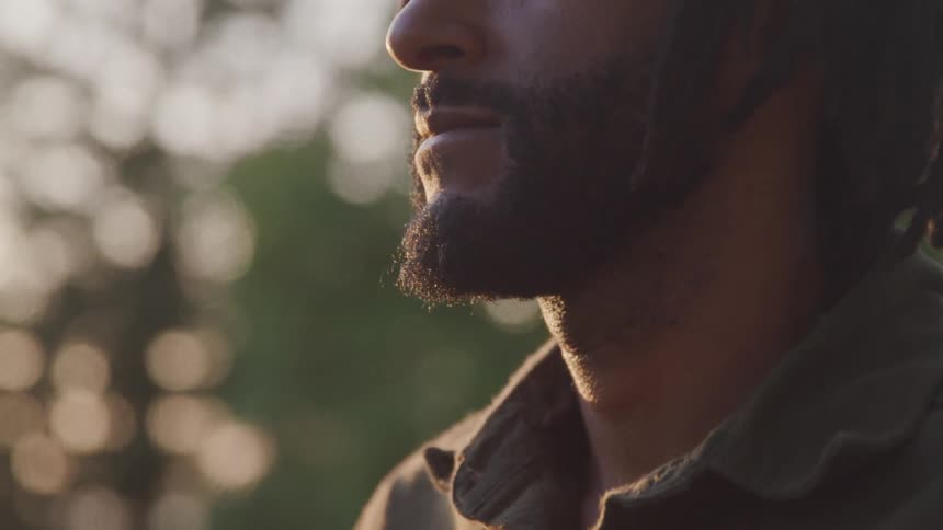A man poses and looks out into the distance