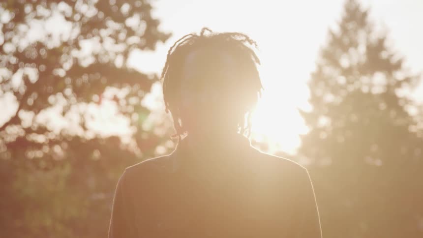 Man with dreads in a park