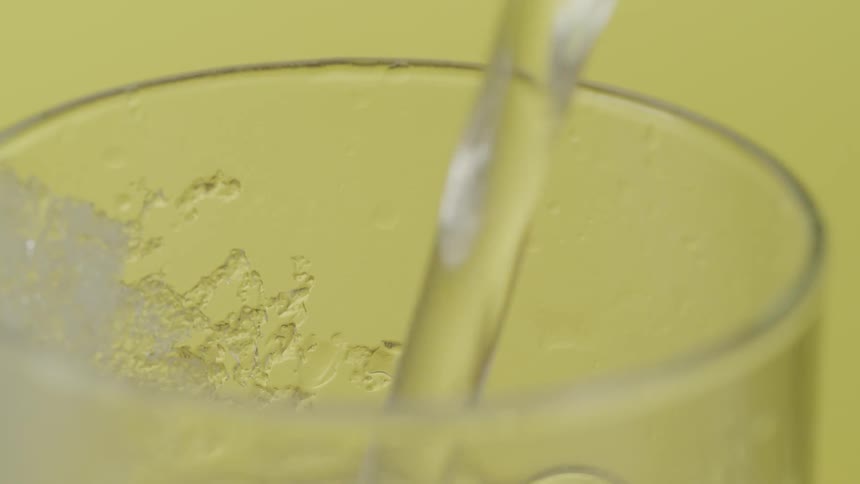 Liquid is being poured into a glass