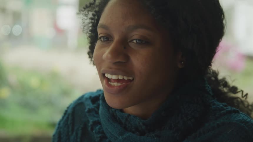 Woman smiles and laughs as she talks