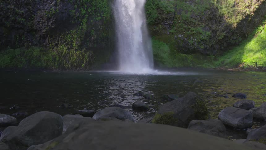 A river is falling from a waterfall outdoors