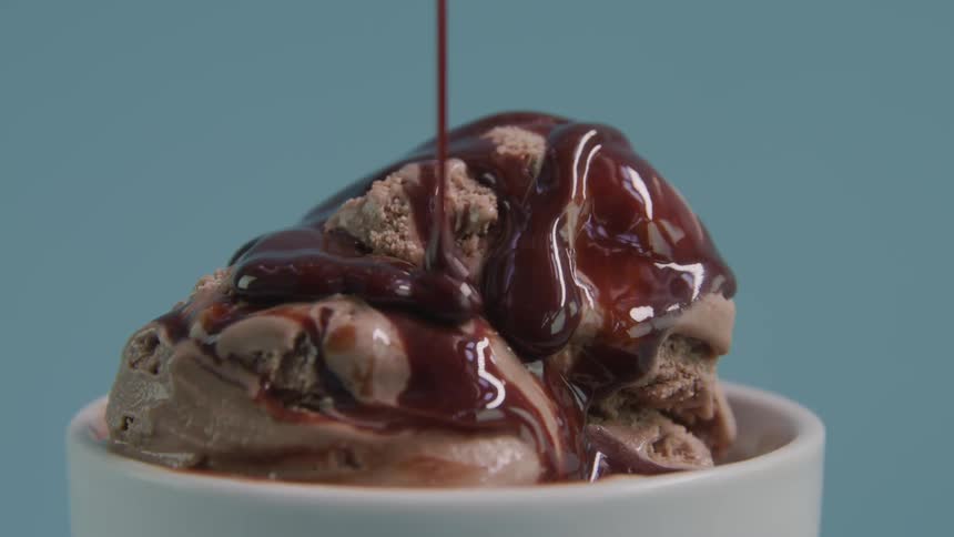 Ice cream with chocolate syrup falling on it