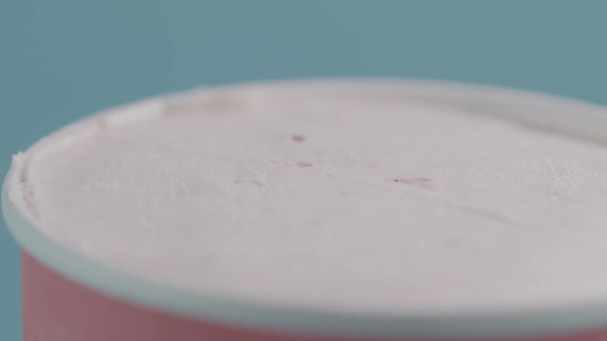 A pint of ice cream is open but untouched