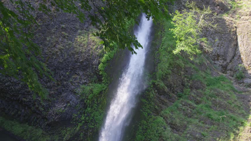 Waterfall rushing water through a gorge in a canyon