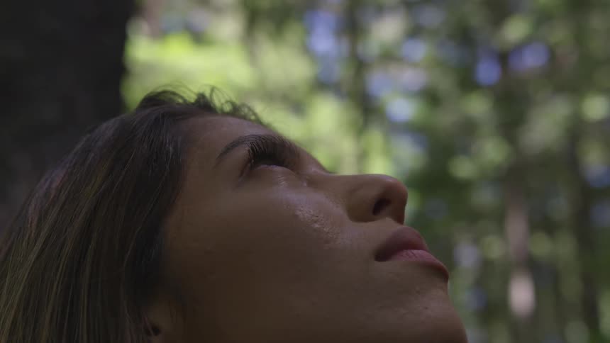 A woman is looking up in the sky