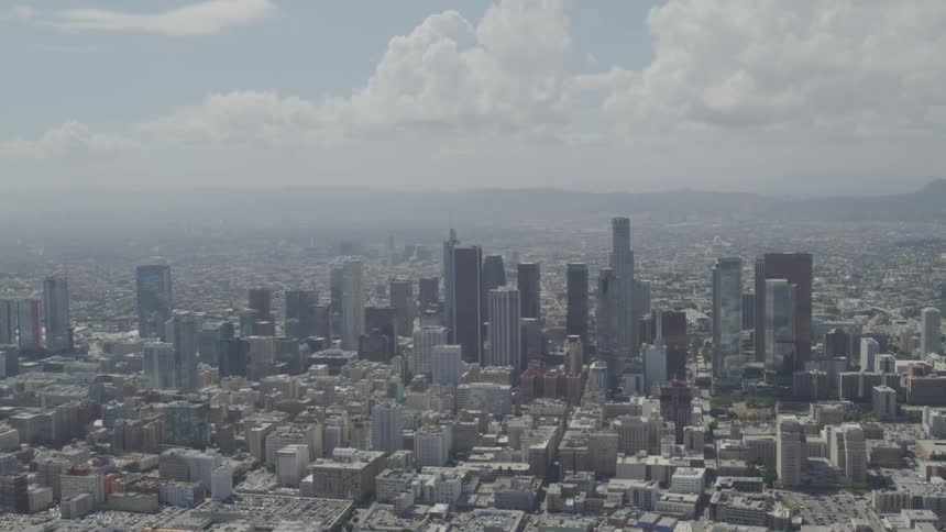 A city with tall buildings and mountains in the background