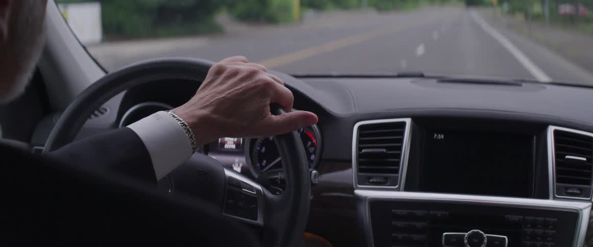A person drives down a road