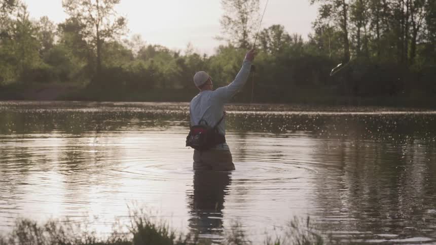 A man casts a fly fishing rod