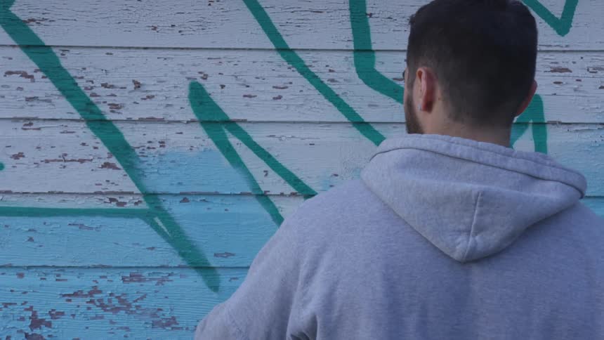 Man spraying paint on a wall