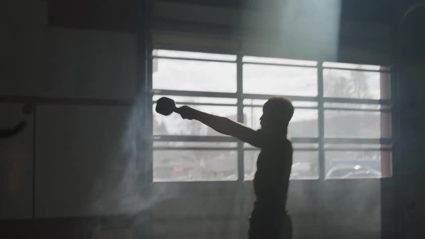 Man working out with a kettle ball