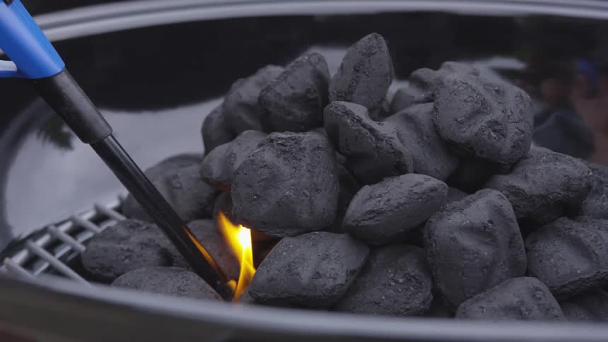 A bunch of charcoal being lit