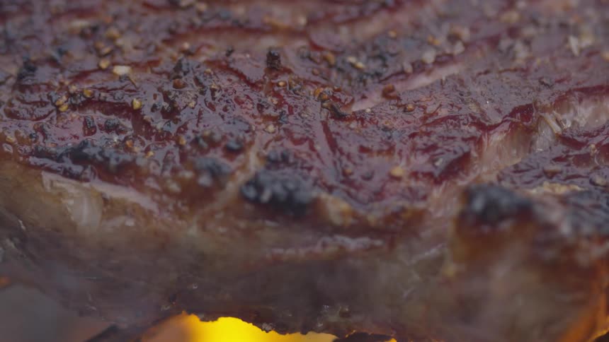 A steak cooking on a grill