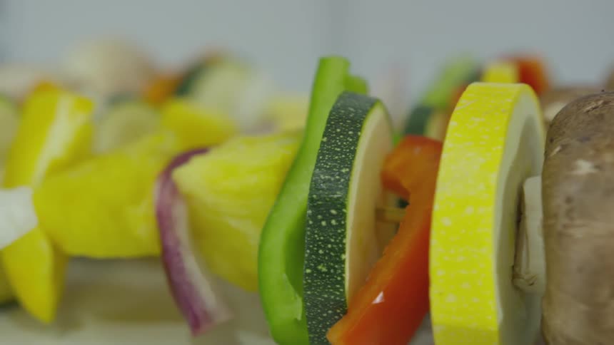 Multiple kabobs of vegetables on a plate