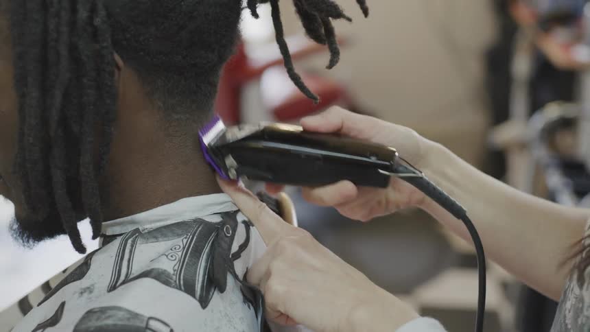 A man getting his hair cut in a barber shop