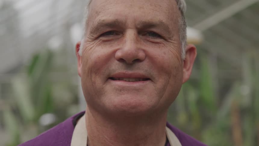 An older white man smiles