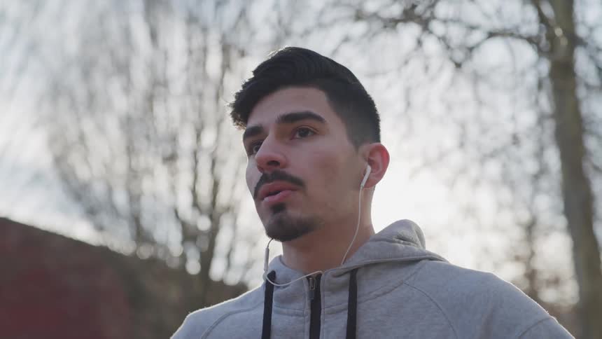 Man wearing hoodie and headphones at the winter